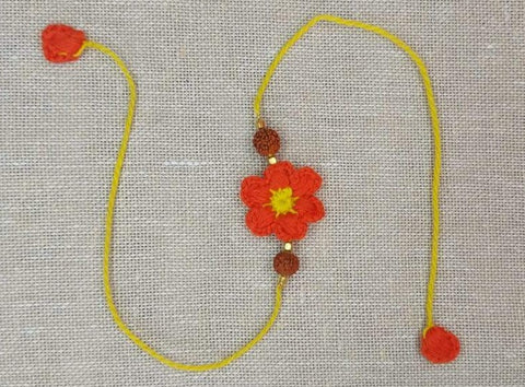 Handmade Crochet Rakhi with Rudraksh - Orange Flower