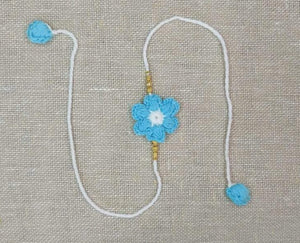 Handmade Crochet Rakhi with Beads - Blue & White Flower