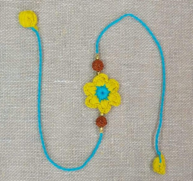 Handmade Crochet Rakhi with Rudraksh - Yellow & Blue Flower