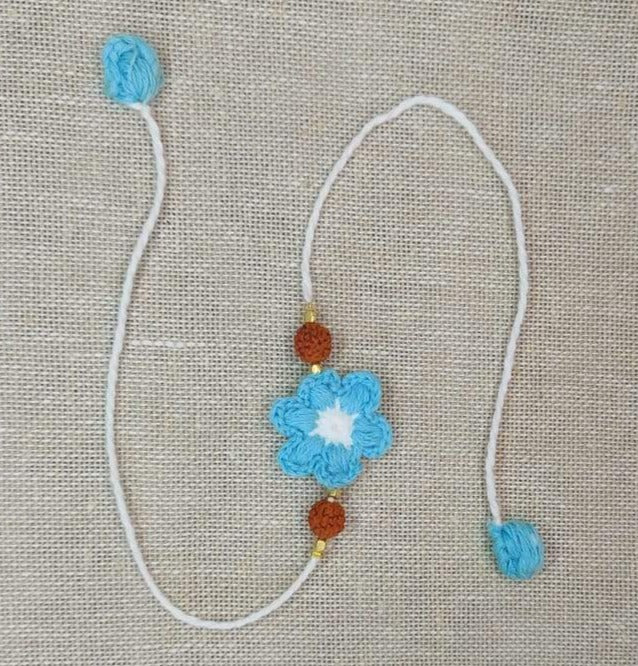 Handmade Crochet Rakhi with Rudraksh - Blue & White Flower